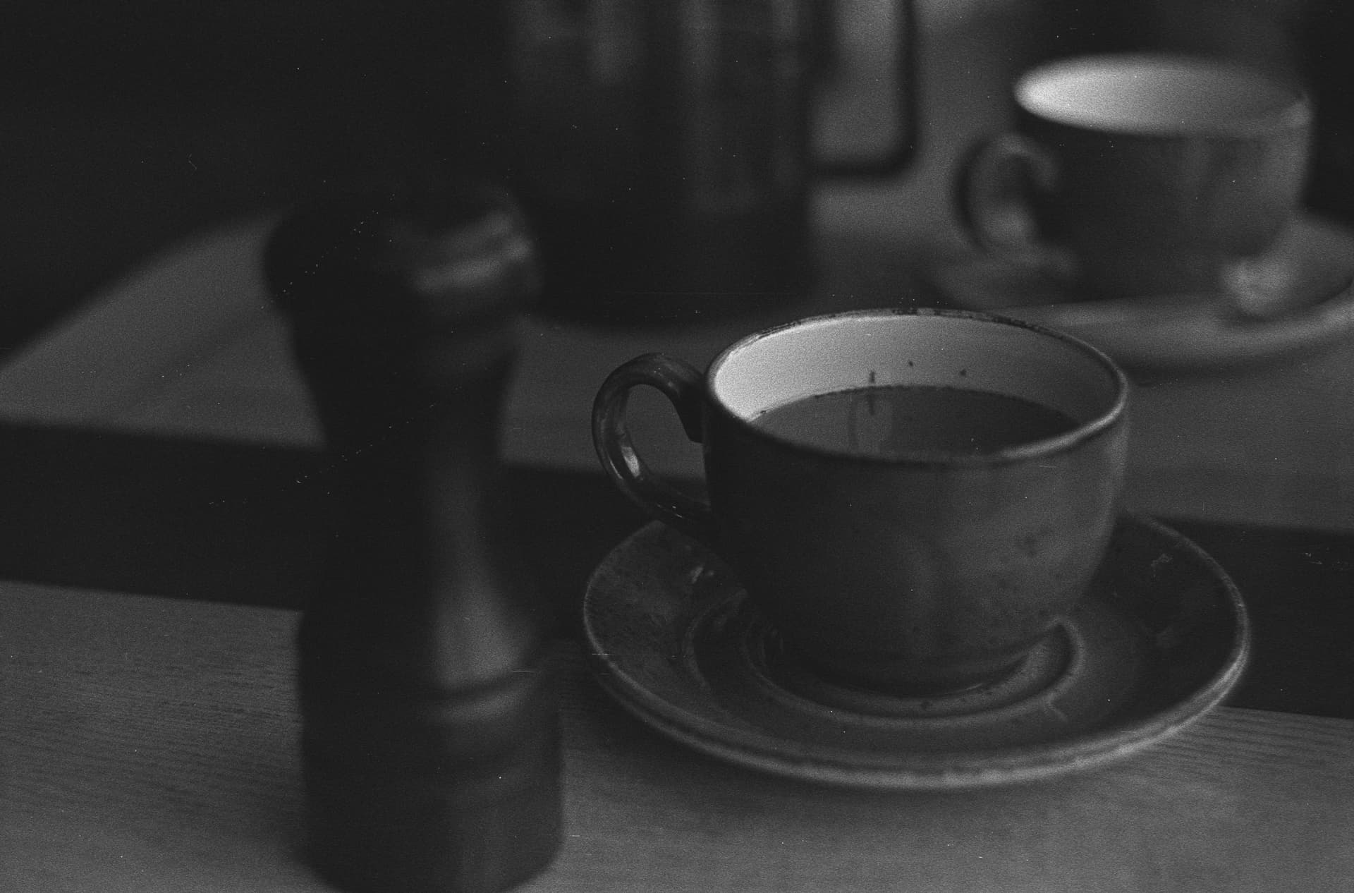 A coffee grinder and loose leaf tea side by side on a counter