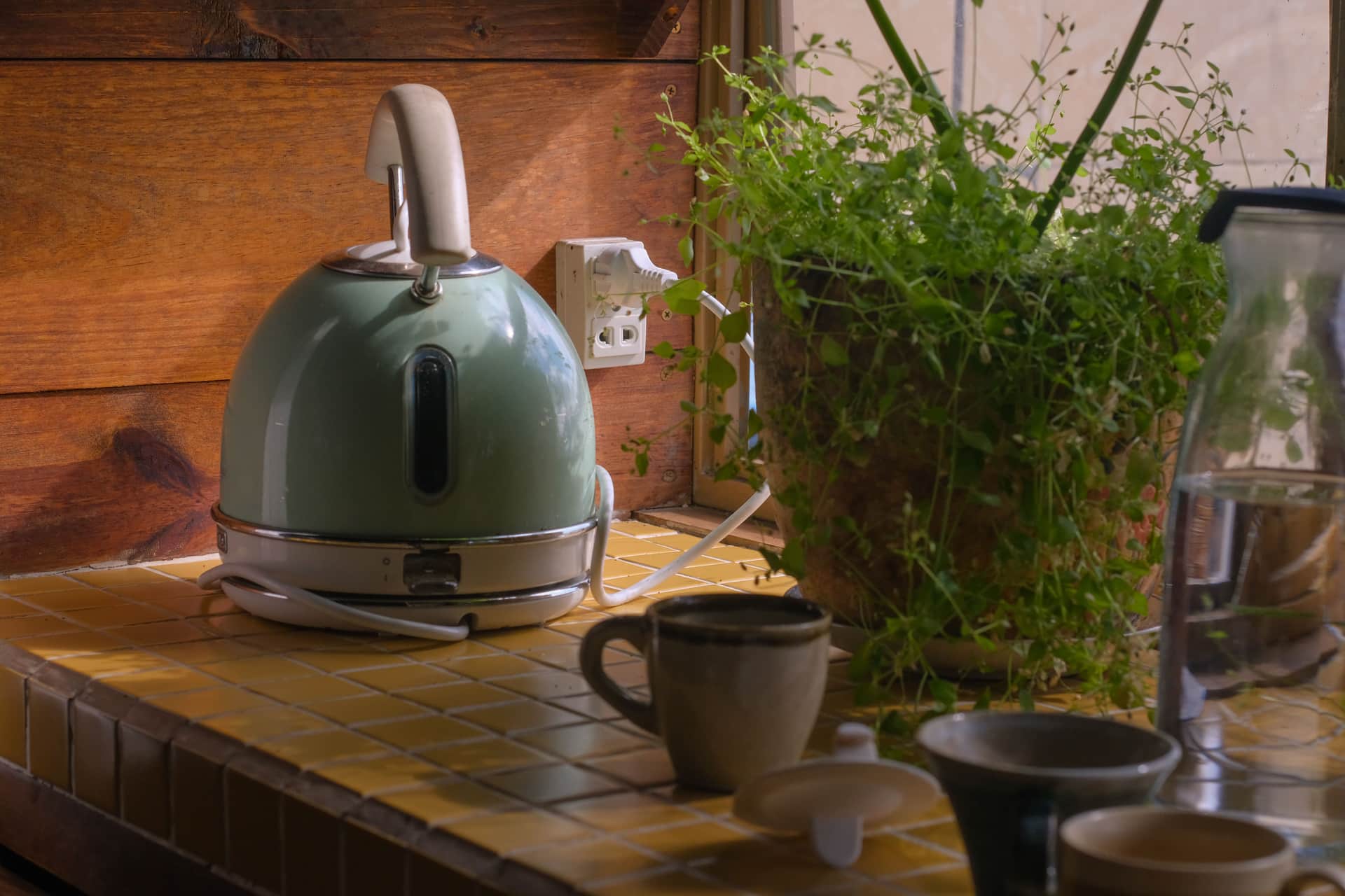 A simple kettle and a single mug on a kitchen counter