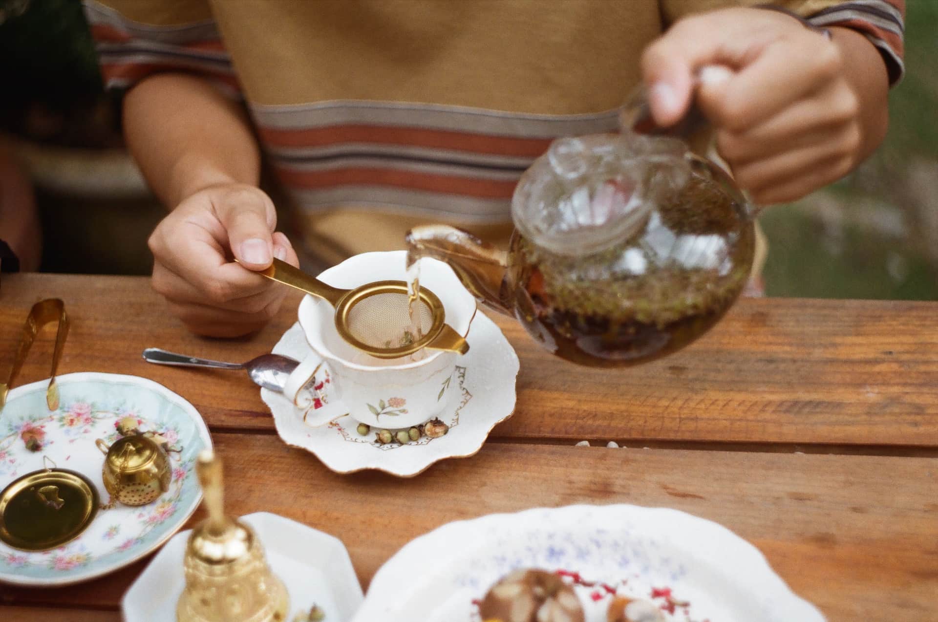 Hot water being poured over tea leaves in an infuser